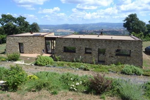 a stone house on a hill with a garden at Agriturismo Affaccio su Orvieto in Orvieto