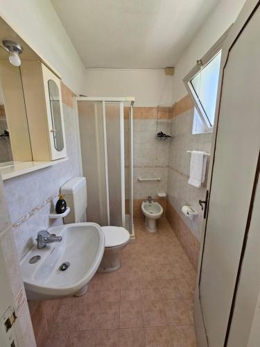 a bathroom with a sink and a toilet at Residence Limoneto Ischia in Ischia