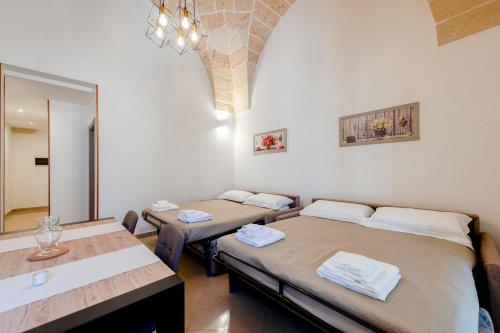 a room with two beds and a mirror at San Giorgio Apartment in Cavallino di Lecce