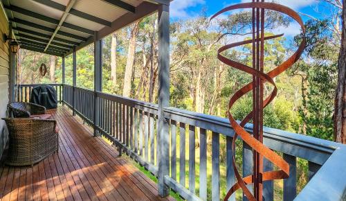 a large metal sculpture on the porch of a house at Tarilta Cottage in Hepburn Springs