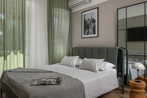 a bedroom with a bed with two magazines on it at Agostini Residence - SELF CHECK-IN ONLY in Rijeka