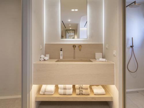 a bathroom with a sink and a mirror at The Villas by Santo Collection in Oia