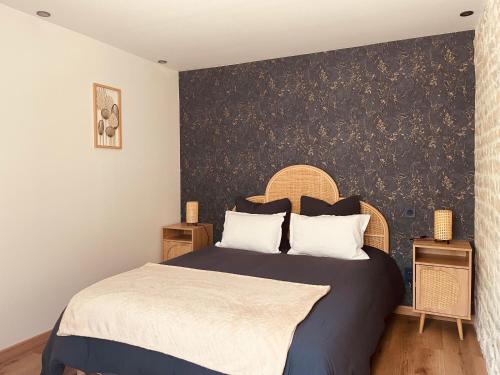 - une chambre dotée d'un lit avec un mur aux accents noirs dans l'établissement Gîte chez René, à Fresville