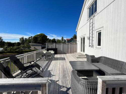 a wooden deck with a table and chairs on a building at House by the ocean in Mariehamn in Mariehamn