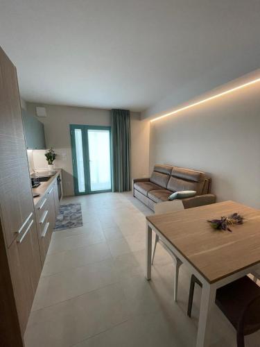 a living room with a couch and a table at Villa Arlini in Pineto