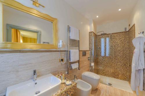 a bathroom with a sink and a mirror and a shower at Hotel San Zaccaria in Venice