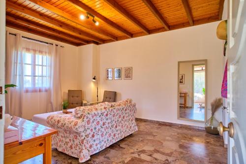 a living room with a couch and a table at Kodelo summer house in Corfu