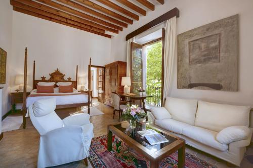 a living room with a couch and a bed at La Residencia, A Belmond Hotel, Mallorca in Deia