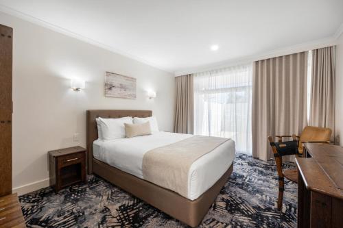 a hotel room with a bed and a desk at Best Western Adelaide Airport in Adelaide