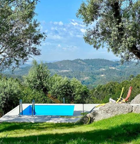 a blue bench sitting on top of a field at Cantinho da Pereira in Lugar