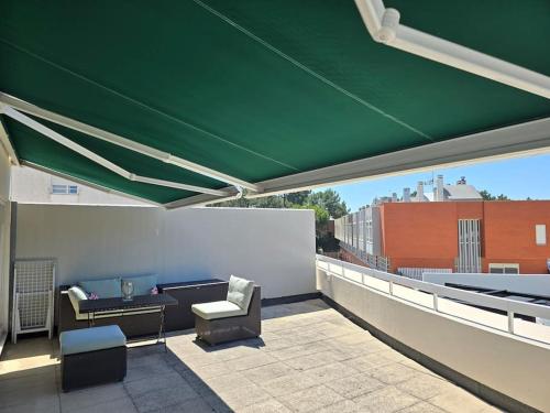 a green canopy on top of a roof at Viana beach apartment in Viana do Castelo