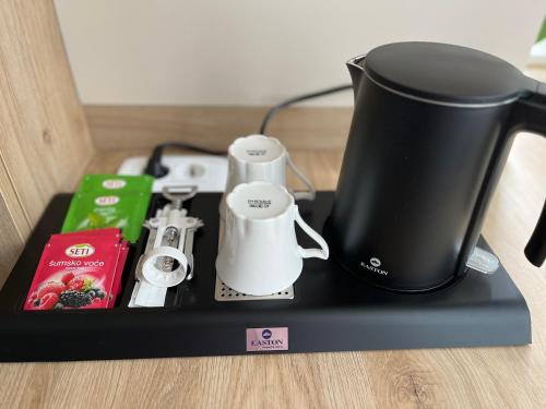 a black tray with a coffee maker and a blender at Rina Apartments in Sarajevo