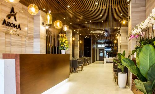 a restaurant with tables and chairs and plants at Ocean View Nha Trang in Nha Trang