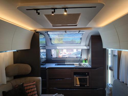 an interior view of a kitchen in an rv at wecamp Jávea in Jávea