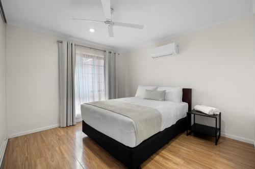 a white bedroom with a bed and a window at Best Western Adelaide Airport in Adelaide