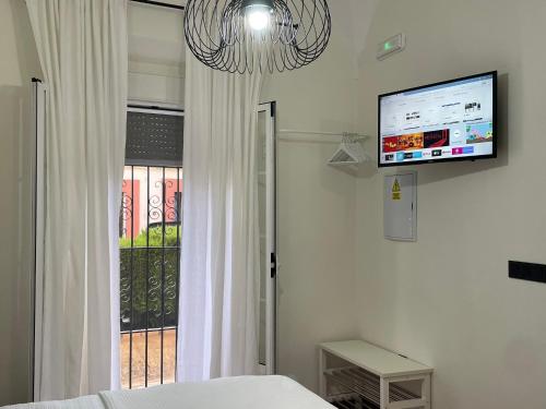 a bedroom with a bed and a tv on the wall at Apartamento Casa Nela in Medellín