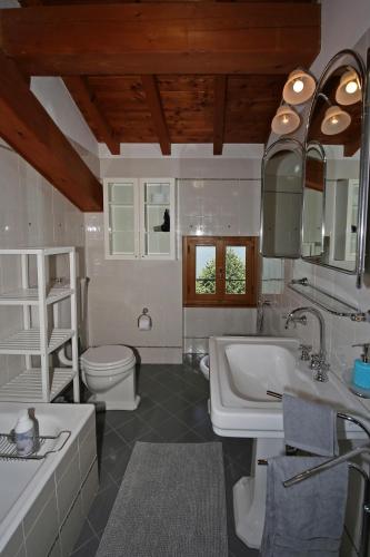 a bathroom with a sink and a toilet at Villa La Punta in Bellagio