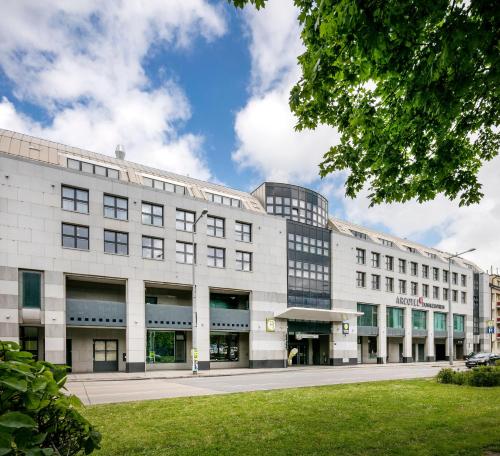 a large white building on a city street at ARCOTEL Donauzentrum Wien in Vienna