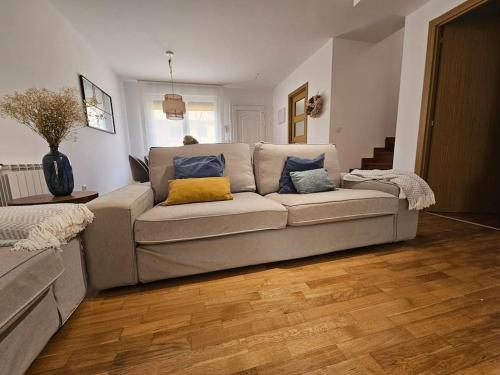 a living room with a couch with pillows on it at Casa Rovacias Comillas C22A01 in Comillas