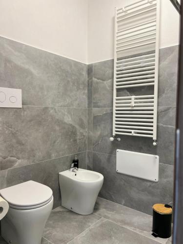 a bathroom with a toilet and a sink at Harmony Affittacamere in Tortolì