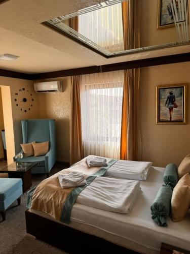 a bedroom with a large bed and a window at Villa Aroma 2 in Orašje