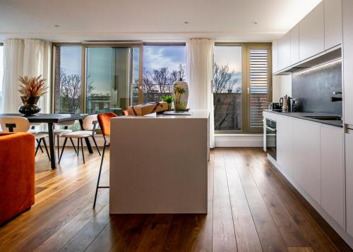 a kitchen and living room with a table and chairs at The Castle Suite @ Ryedale House in York