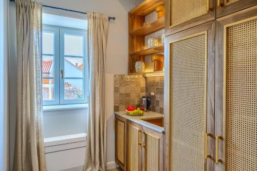 a kitchen with a sink and a window at Hotel Brattia, Adults Only, Heated Pool, A la Carte Breakfast, Postira, Brač Island in Postira