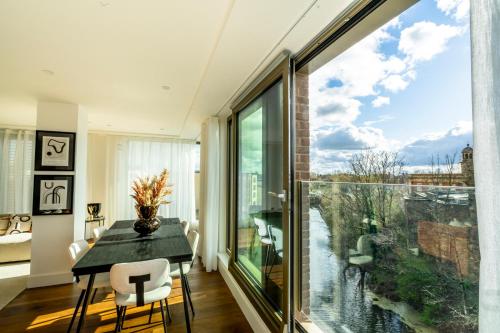 a dining room with a table and a large window at The Castle Suite @ Ryedale House in York