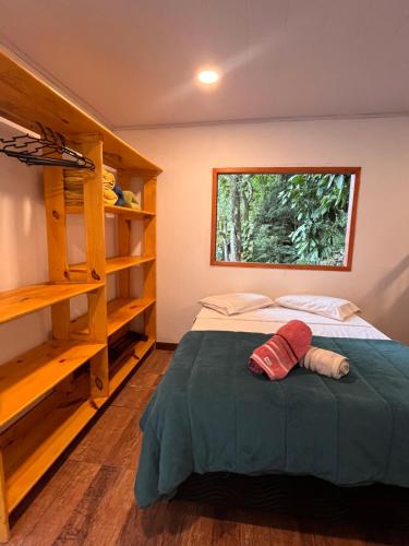 a bedroom with a bed and a window at Fauna in Praia do Bananal