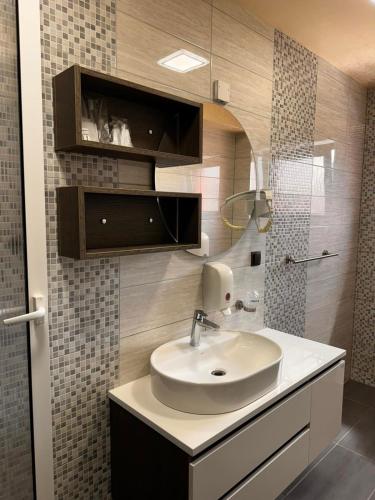 a bathroom with a sink and a mirror at Villa Aroma 2 in Orašje