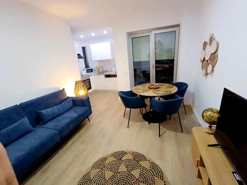 a living room with a blue couch and a table at Camões Appartments in Porto