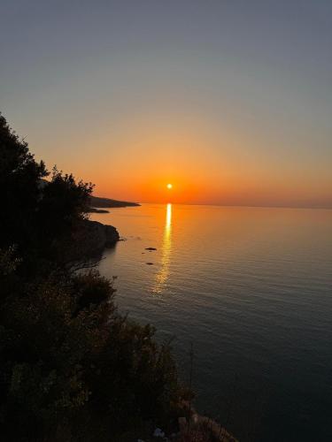 a sunset over a body of water at The Rocas Hotel in Kérynia
