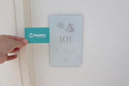a person holding up a thermometer on a door at Adagio Salentino in Porto Cesareo