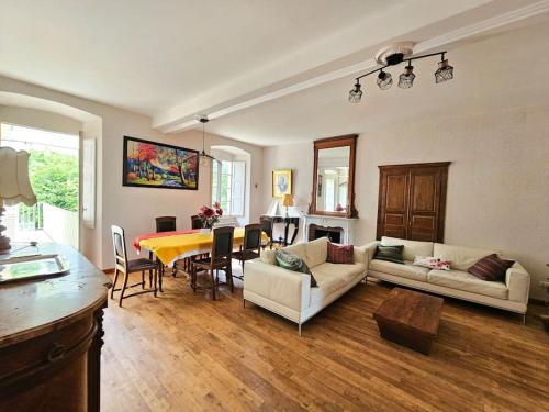 un salon avec une table et une salle à manger dans l'établissement Maison d Americain a Figarella au Cap Corse, à Santa-Maria-di-Lota