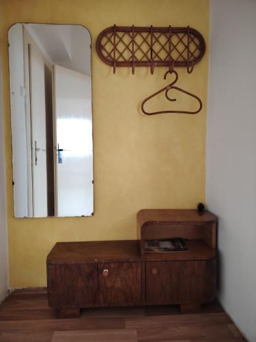 a mirror and a wooden table in a room at Pacov 501 in Pacov