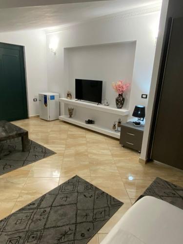 a living room with a flat screen tv on a white wall at Vila Ajdinaj in Berat