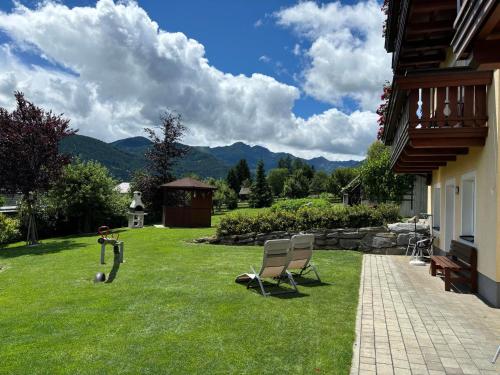 a yard with two lawn chairs and a gazebo at Eckenhof in Sankt Michael im Lungau
