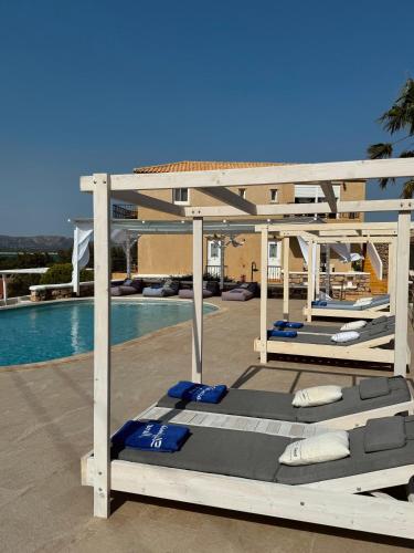 a bed on a patio next to a swimming pool at Elafonisos Mare in Elafonisos