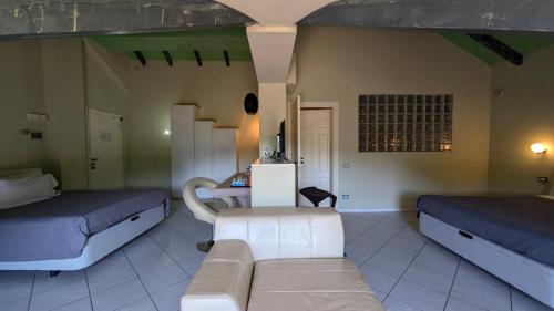 a living room with two beds and a couch at hotel garni Santa Caterina in Orta San Giulio