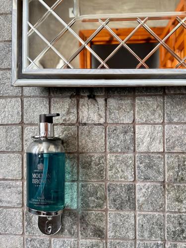 a bottle of mouthwash is sitting on a bathroom sink at Almunia de San Miguel in Toledo