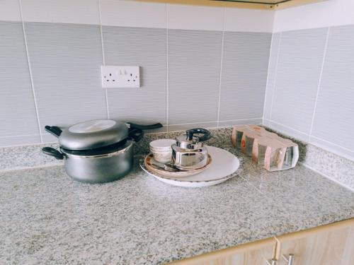 a kitchen counter with a pot and pans on it at أجاويد 2 Ajaweed in Salalah
