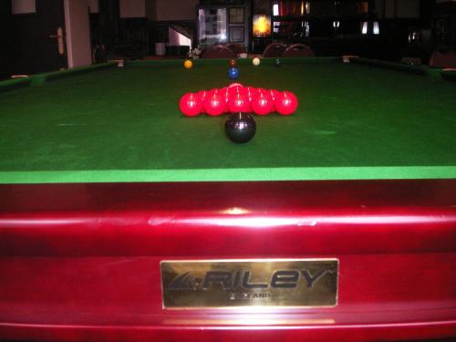 a pool table with a ball on top of it at Metropol Hotel in Calais