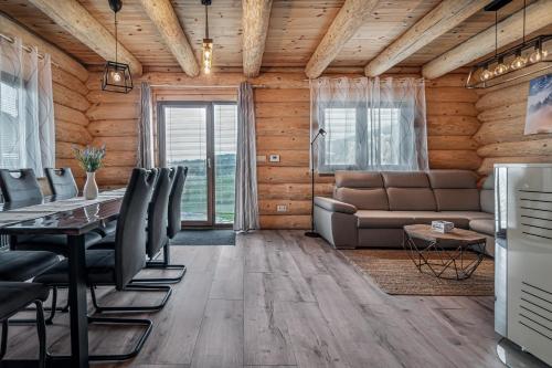 a living room with a table and a couch at Zrub Šumiac in Šumiac