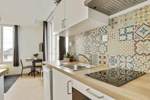 a kitchen with a sink and a counter top at Studio Au Bord du Canal (4B) *Paris*Disney* in Chelles