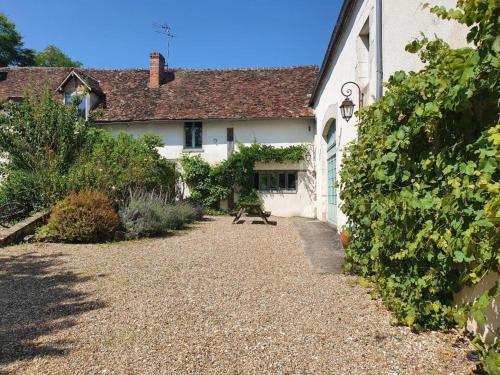 a white house with a gravel driveway in front of it at Ferme équestre & Chambres d'hôtes Gateau Stables proche Guédelon in Saint-Amand-en-Puisaye
