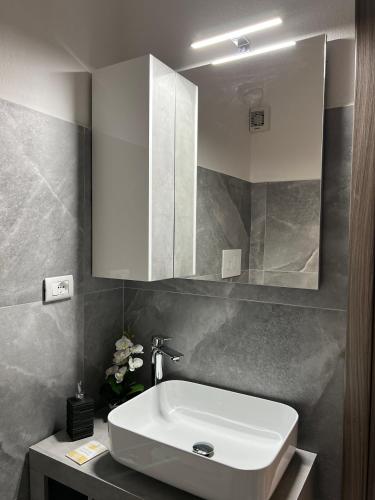 a bathroom with a white sink and a mirror at Harmony Affittacamere in Tortolì
