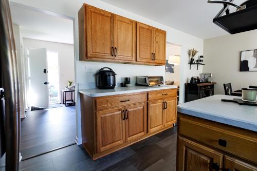 a kitchen with wooden cabinets and a counter top at The Cooper Home, Dogs Welcome! in Ephrata