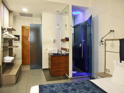 y un baño grande con ducha y lavabo. en Hotel California, en Roma