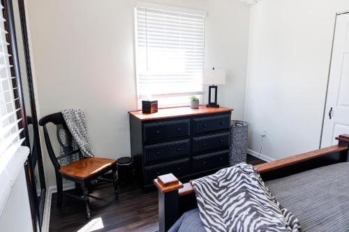 a bedroom with a dresser and a chair and a window at The Cooper Home, Dogs Welcome! in Ephrata