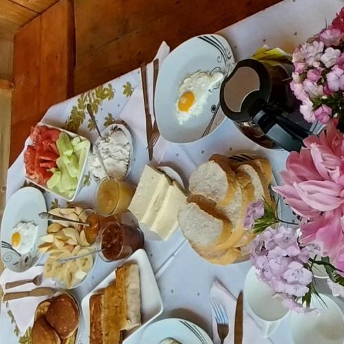 a table topped with plates of eggs and sandwiches at Guesthouse Leno in Tsaldashi